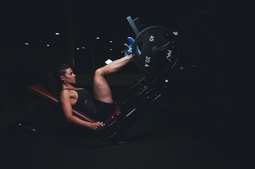 Woman using leg press machine